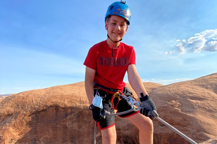 a man riding a bike down a dirt road