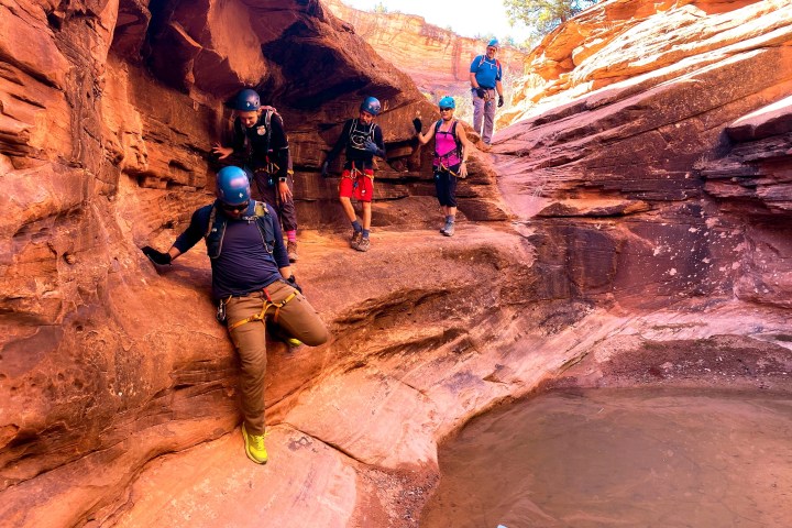 a group of people in a canyon