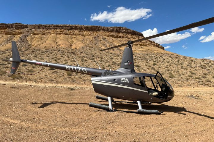 a plane sitting on top of a dirt field