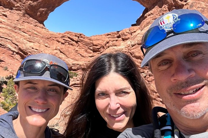 a group of people standing on top of a mountain