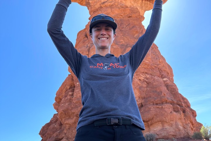 a man standing in front of a mountain